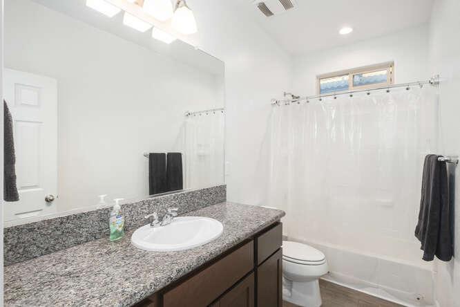 3822 Hannah Lane Clovis, CA 93619 - Photo 23 of 26 a bathroom with a granite countertop sink toilet and shower