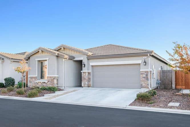 3822 Hannah Lane Clovis, CA 93619 - Photo 6 of 26 a front view of a house with a yard and garage