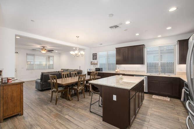 3822 Hannah Lane Clovis, CA 93619 - Photo 8 of 26 a kitchen with a counter top space a sink stainless steel appliances and living room view
