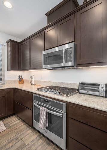 3822 Hannah Lane Clovis, CA 93619 - Photo 10 of 26 a kitchen with granite countertop cabinets stainless steel appliances and sink