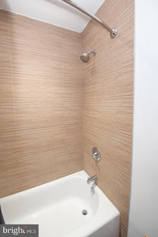 a bathroom with a sink a shower and a mirror