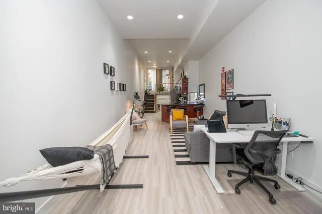 a workspace with furniture and wooden floor