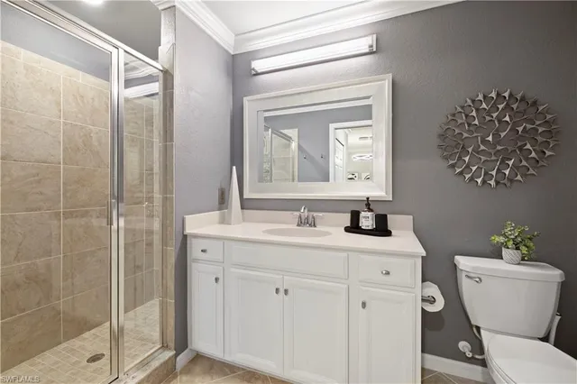 a bathroom with a granite countertop sink a toilet and a mirror