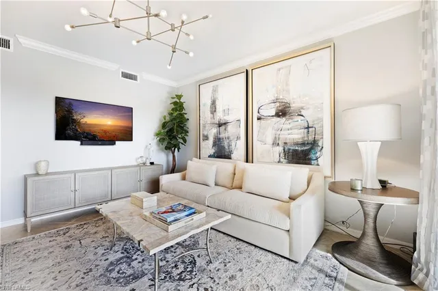 a living room with furniture a flat screen tv and a floor to ceiling window