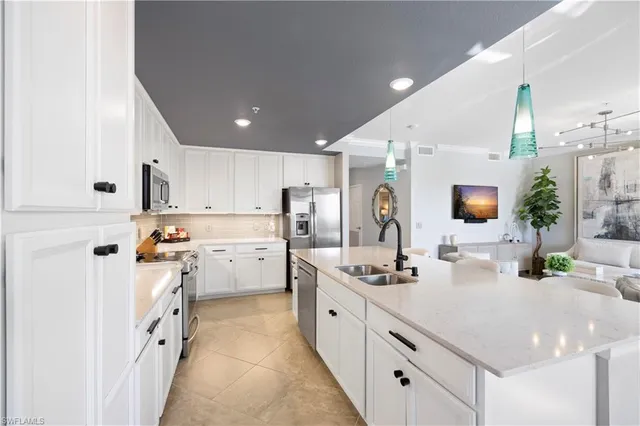a kitchen with a sink refrigerator and cabinets