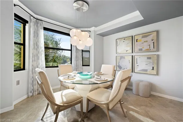 a dining room with furniture a rug and a large window