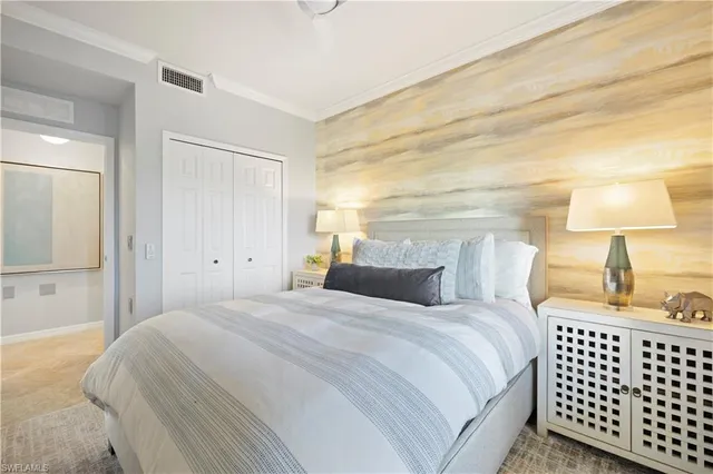 a bedroom with a bed and a lamp