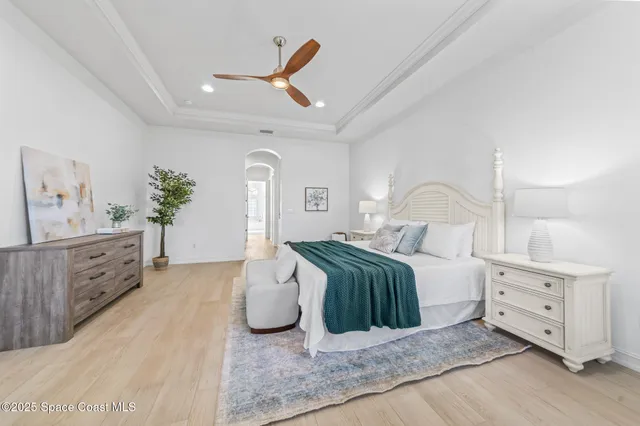 a bathroom with a toilet sink vanity granite and shower