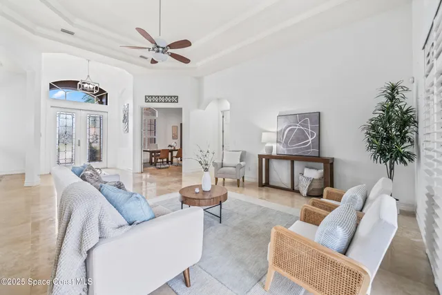 a living room with furniture and a view of kitchen