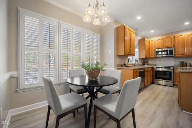 a kitchen with a refrigerator a sink and wooden cabinets