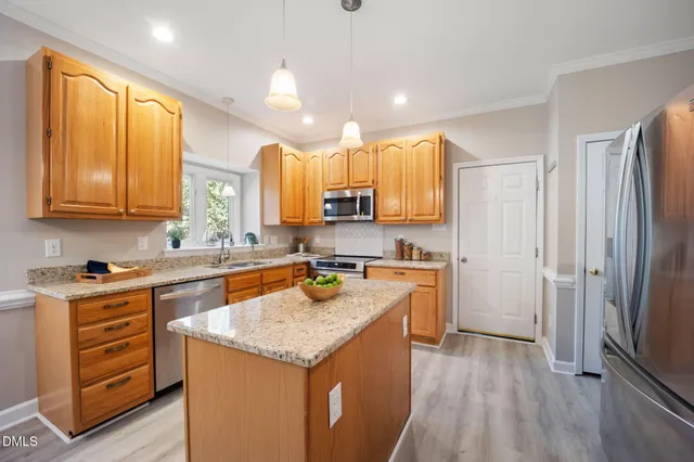 a kitchen with granite countertop a sink stove and cabinets