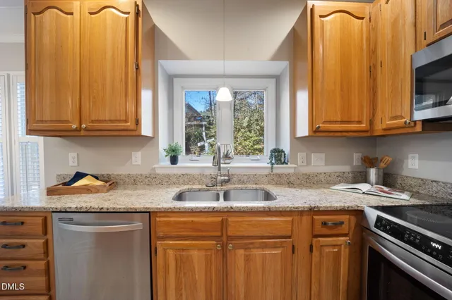 a dining room with furniture a chandelier and wooden floor