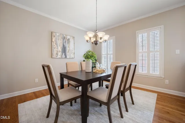 a dining room with furniture and a dining table with wooden floor