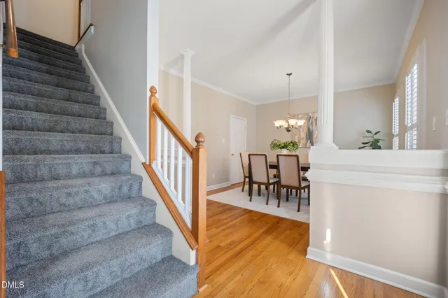 a bedroom with a large bed and a chandelier fan