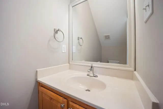 a spacious bedroom with a bed and a chandelier