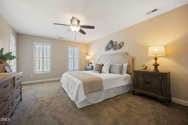 a bedroom with a bed and dresser with mirror