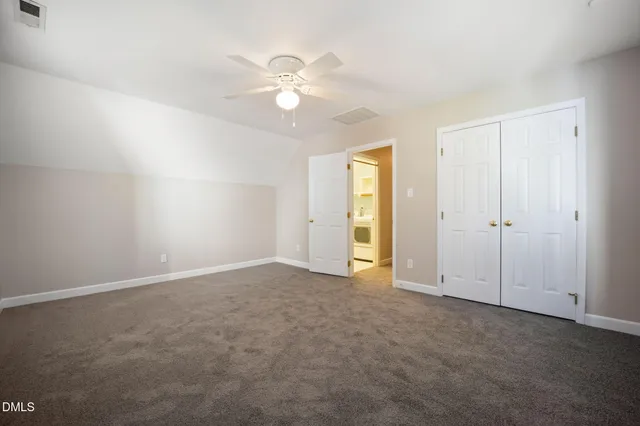 an aerial view of residential house with outdoor space and trees all around