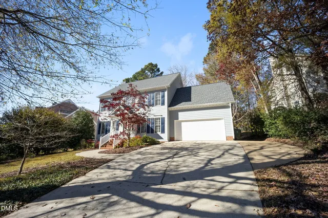 a view of a white house with a snow on the road