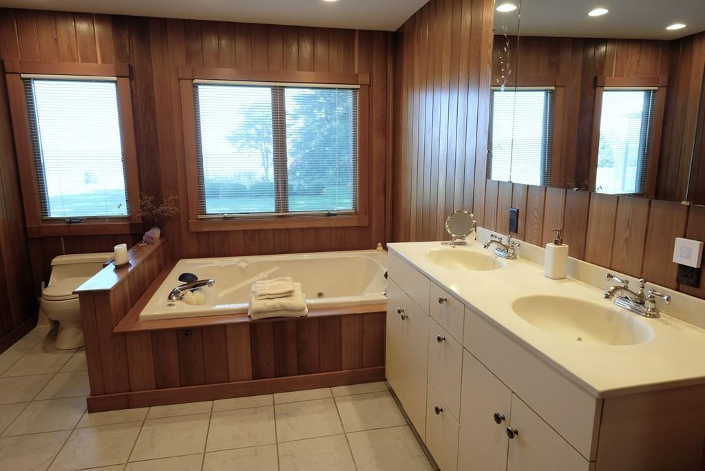 69 Piney Point Road Marion, MA 02738 - Photo 13 of 16 a bathroom with a tub sink and mirror