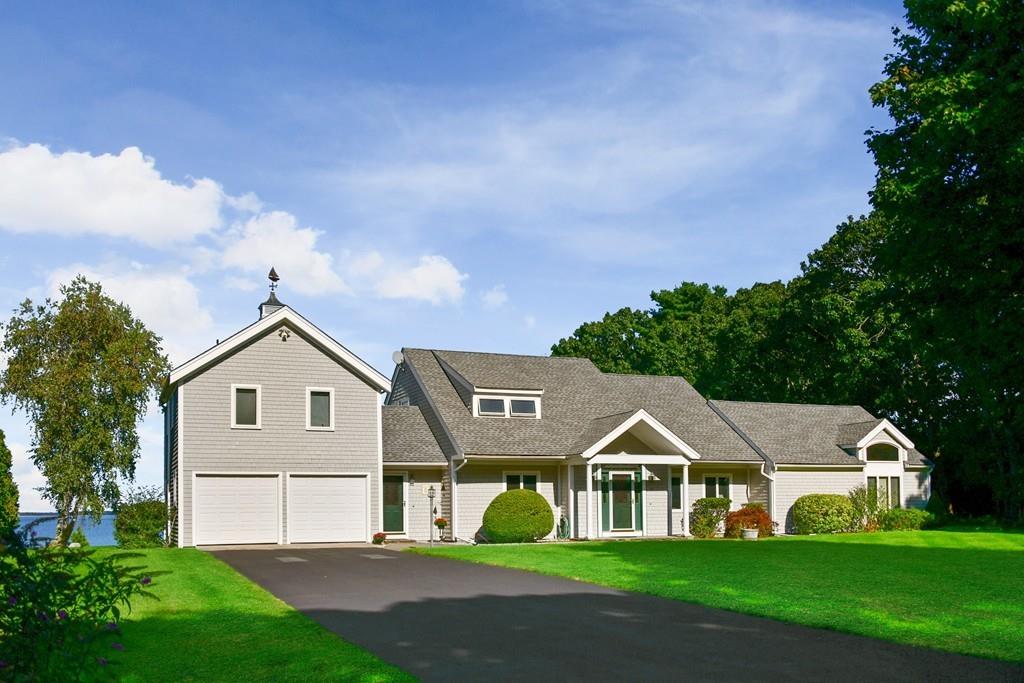 69 Piney Point Road Marion, MA 02738 - Photo 5 of 16 a front view of a house with garden