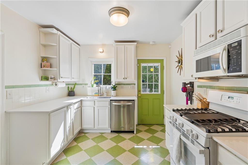2494 Batavia Street Atlanta, GA 30344 - Photo 18 of 48 a kitchen with a stove sink and cabinets