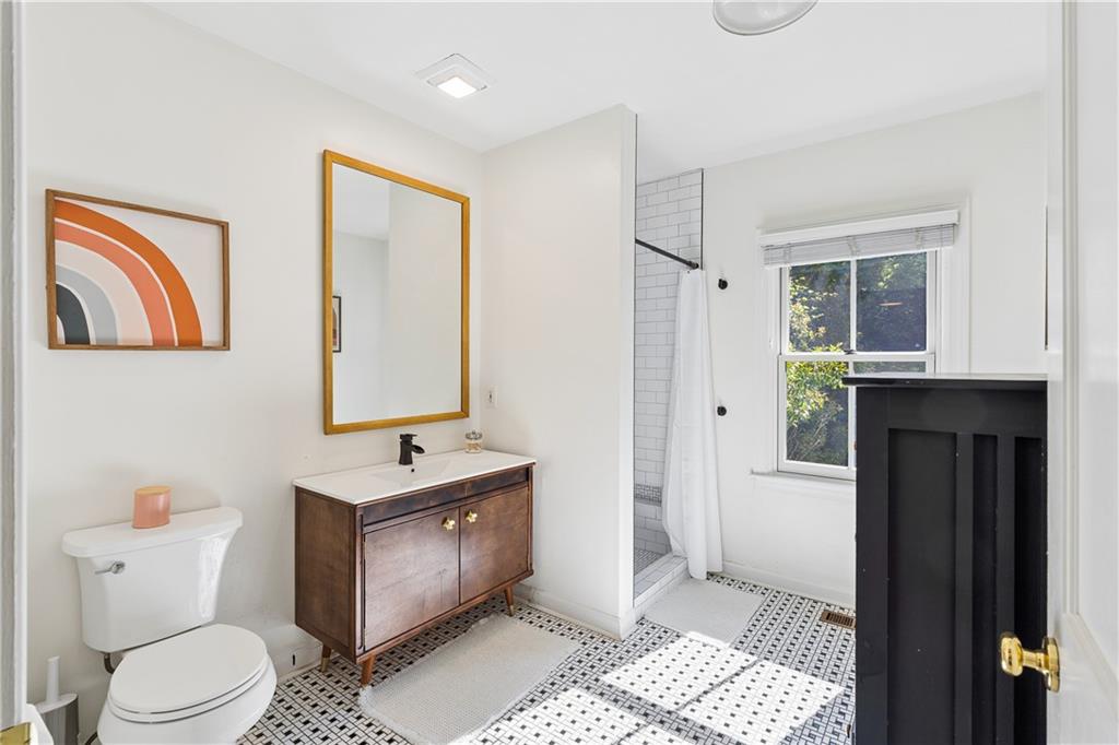 2494 Batavia Street Atlanta, GA 30344 - Photo 30 of 48 a bathroom with a toilet sink and mirror