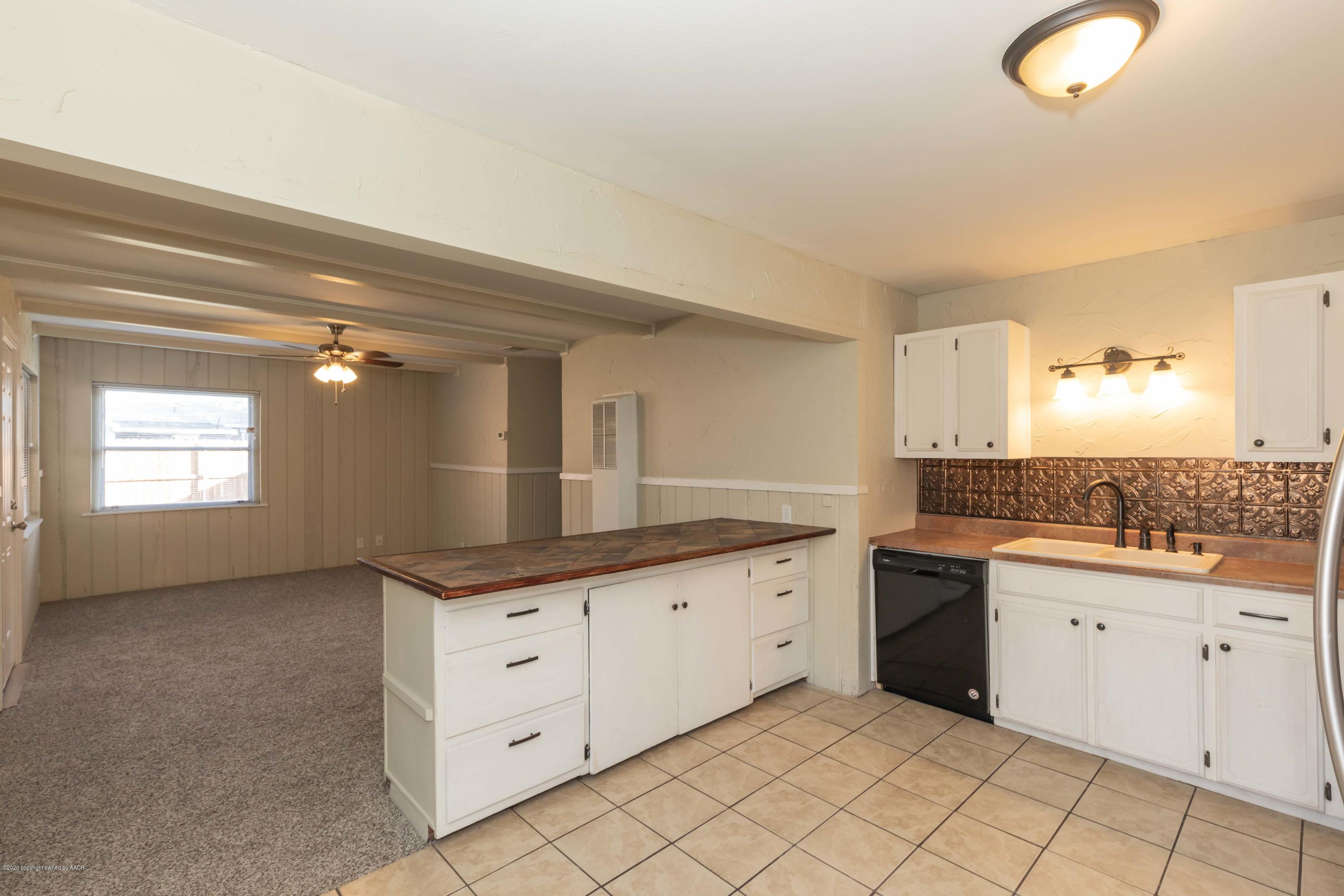518 Southwest 45th Avenue Amarillo, TX 79110 - Photo 12 of 35 a kitchen with granite countertop a sink and dishwasher