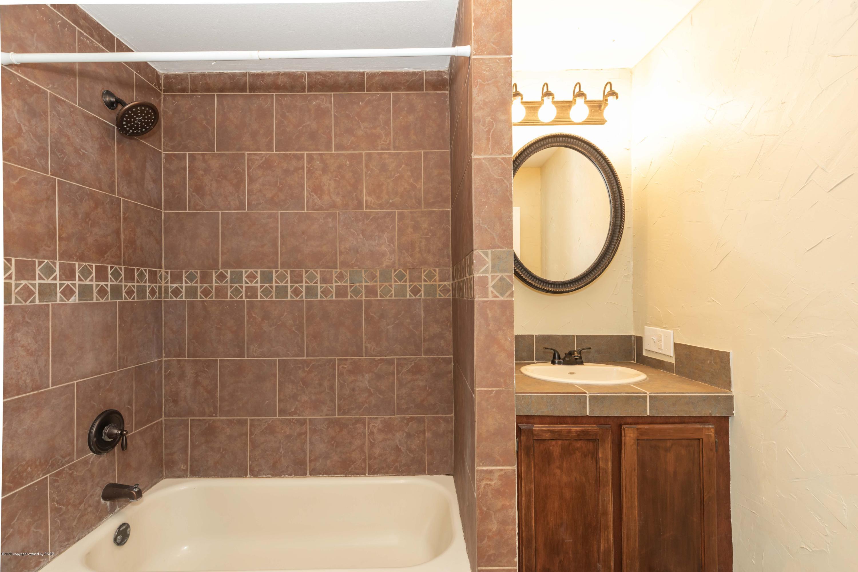 518 Southwest 45th Avenue Amarillo, TX 79110 - Photo 26 of 35 a bathroom with a sink a toilet and a mirror
