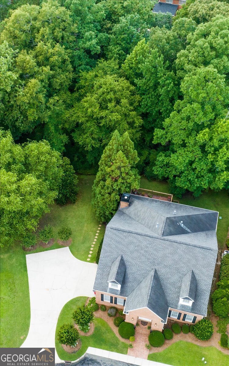 a aerial view of a house with yard and green space