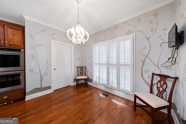a view of a livingroom with wooden floor and a window