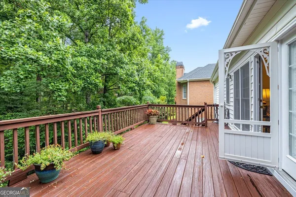 a view of balcony with wooden floor and seating space