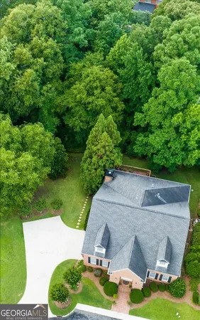 a aerial view of a house with yard and green space