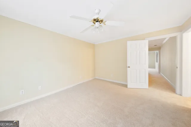 a view of a room with a ceiling fan and a window