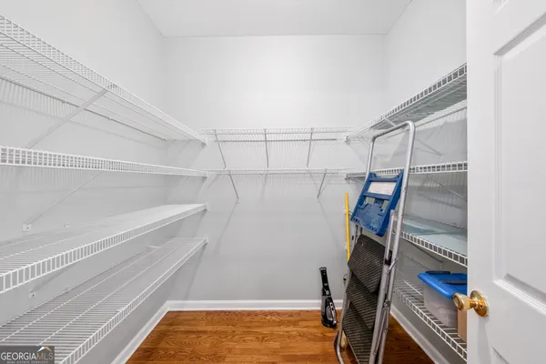 a view of walk in closet with empty racks