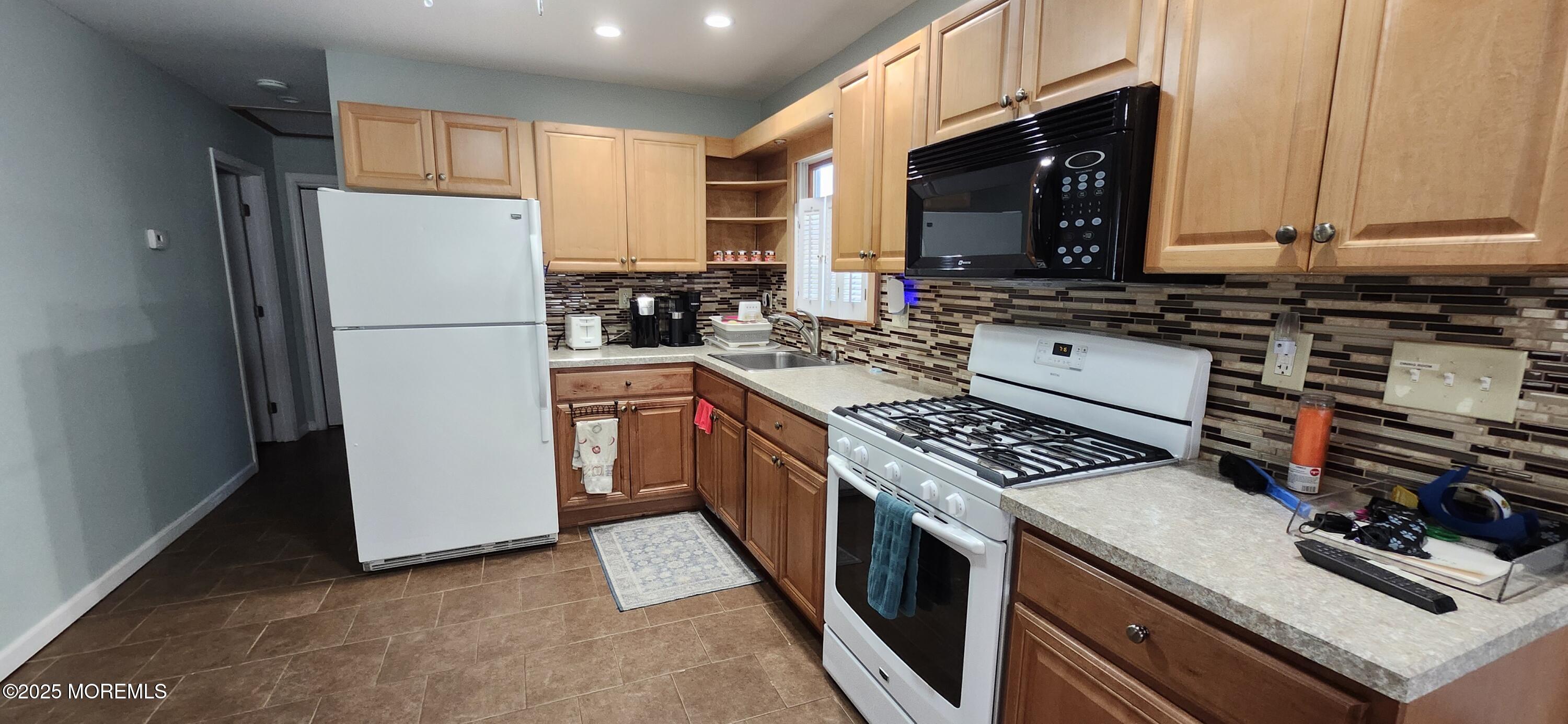 1045 Radio Road Little Egg Harbor, NJ 08087 - Photo 5 of 16 a kitchen with a stove a sink and a refrigerator