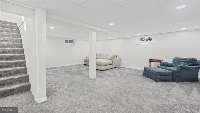 a living room with furniture and white walls