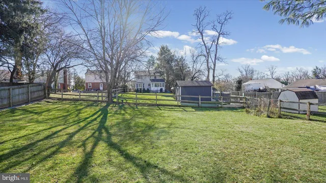 a swimming pool with outdoor seating and yard