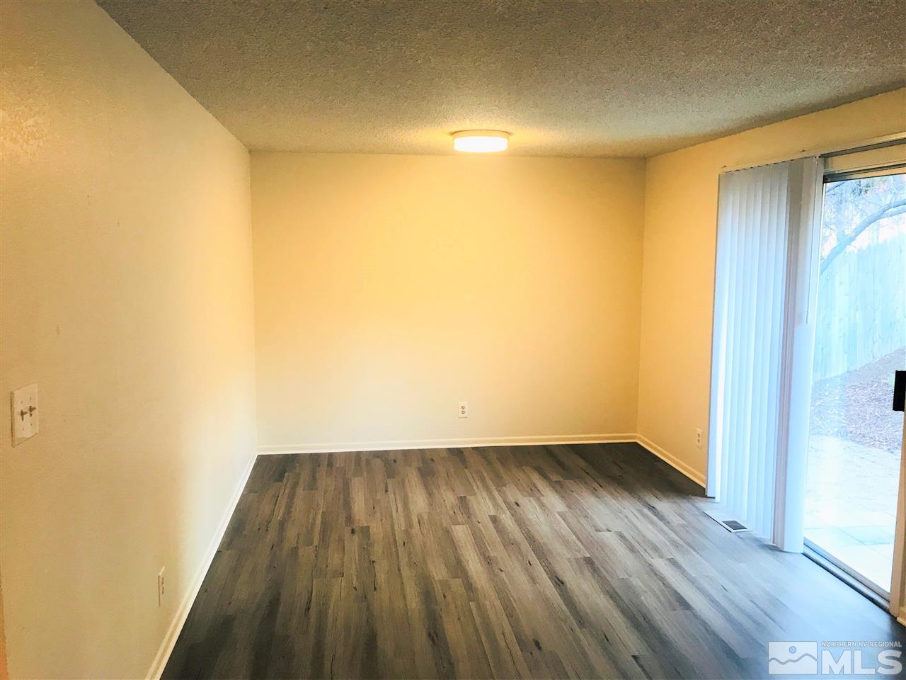 3912 Kings Row Reno, NV 89503 - Photo 4 of 10 a view of a room with wooden floor and brick walls