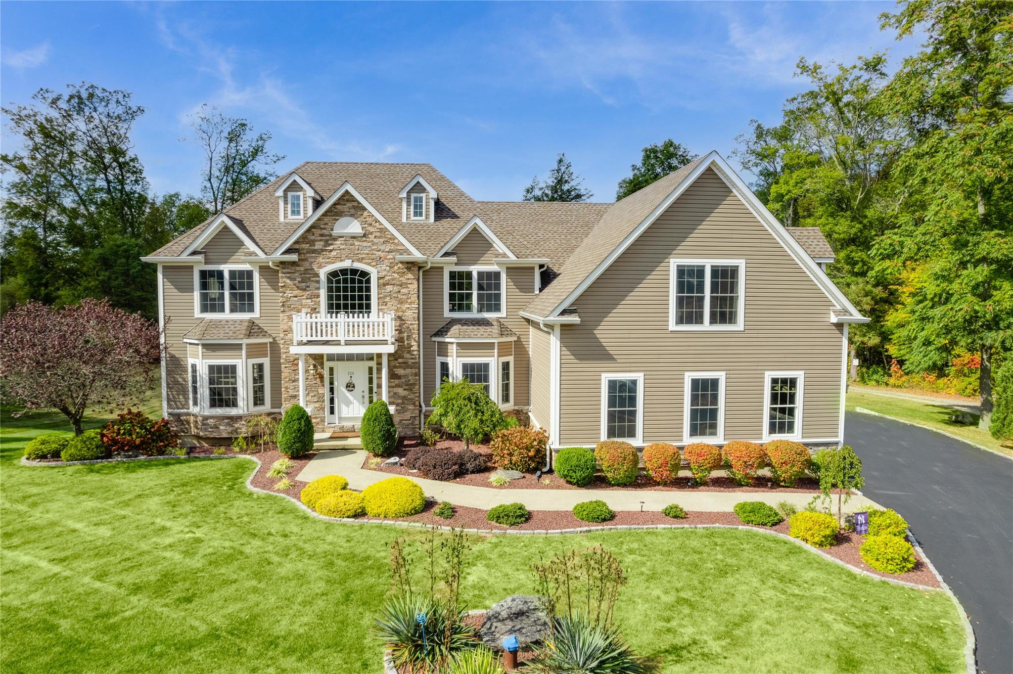a front view of house with yard and green space