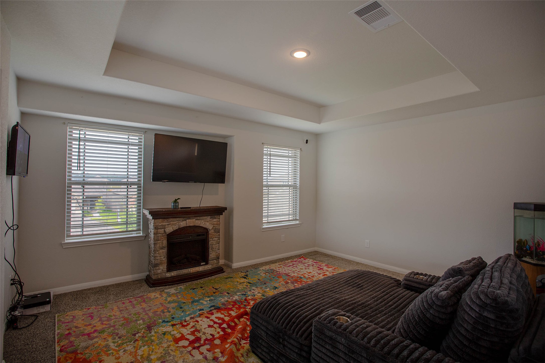 14212 Shasta Ridge Drive Conroe, TX 77303 - Photo 10 of 21 a bedroom with a bed a fireplace and a television