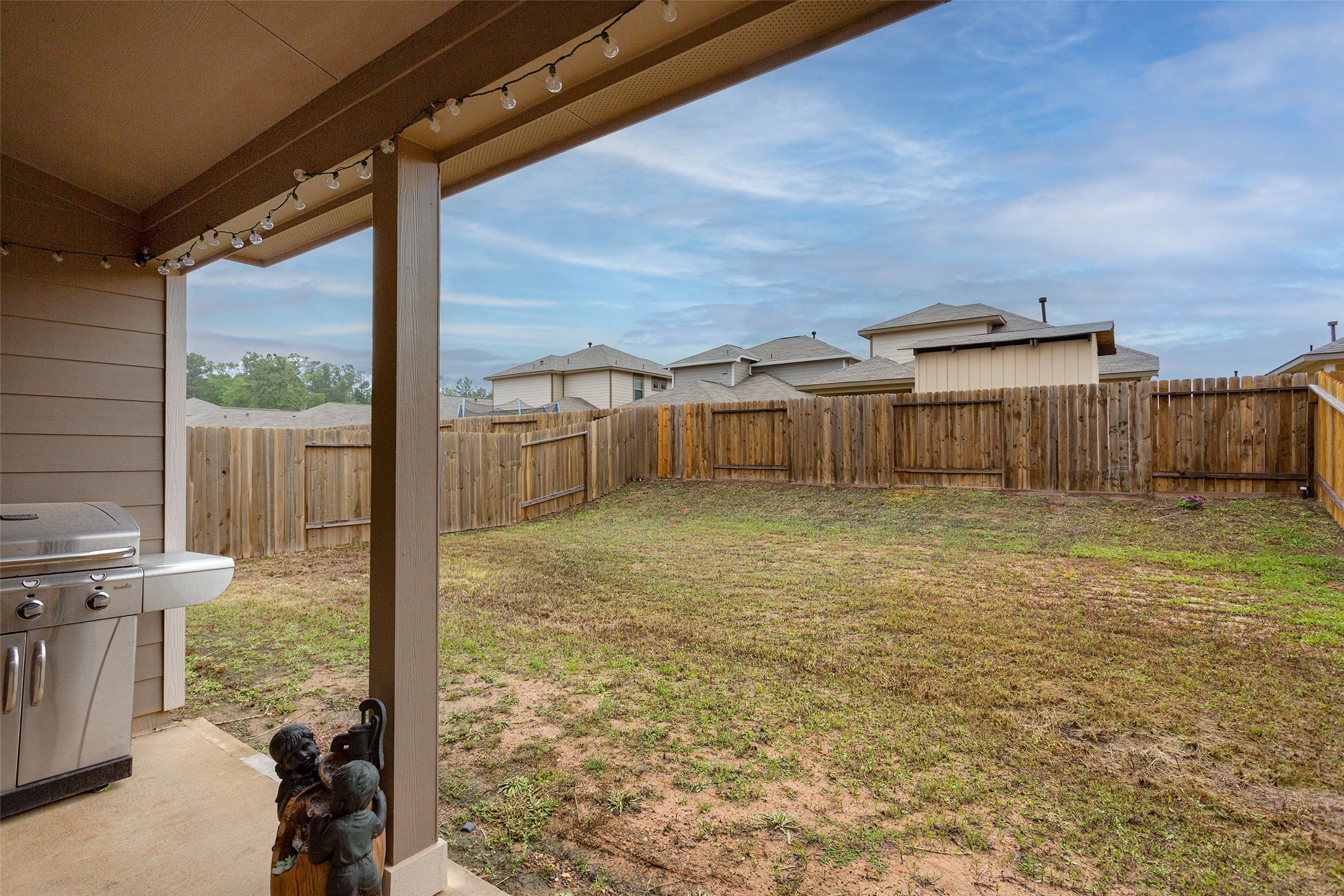 14212 Shasta Ridge Drive Conroe, TX 77303 - Photo 17 of 21 a view of a balcony with table and chairs and wooden fence