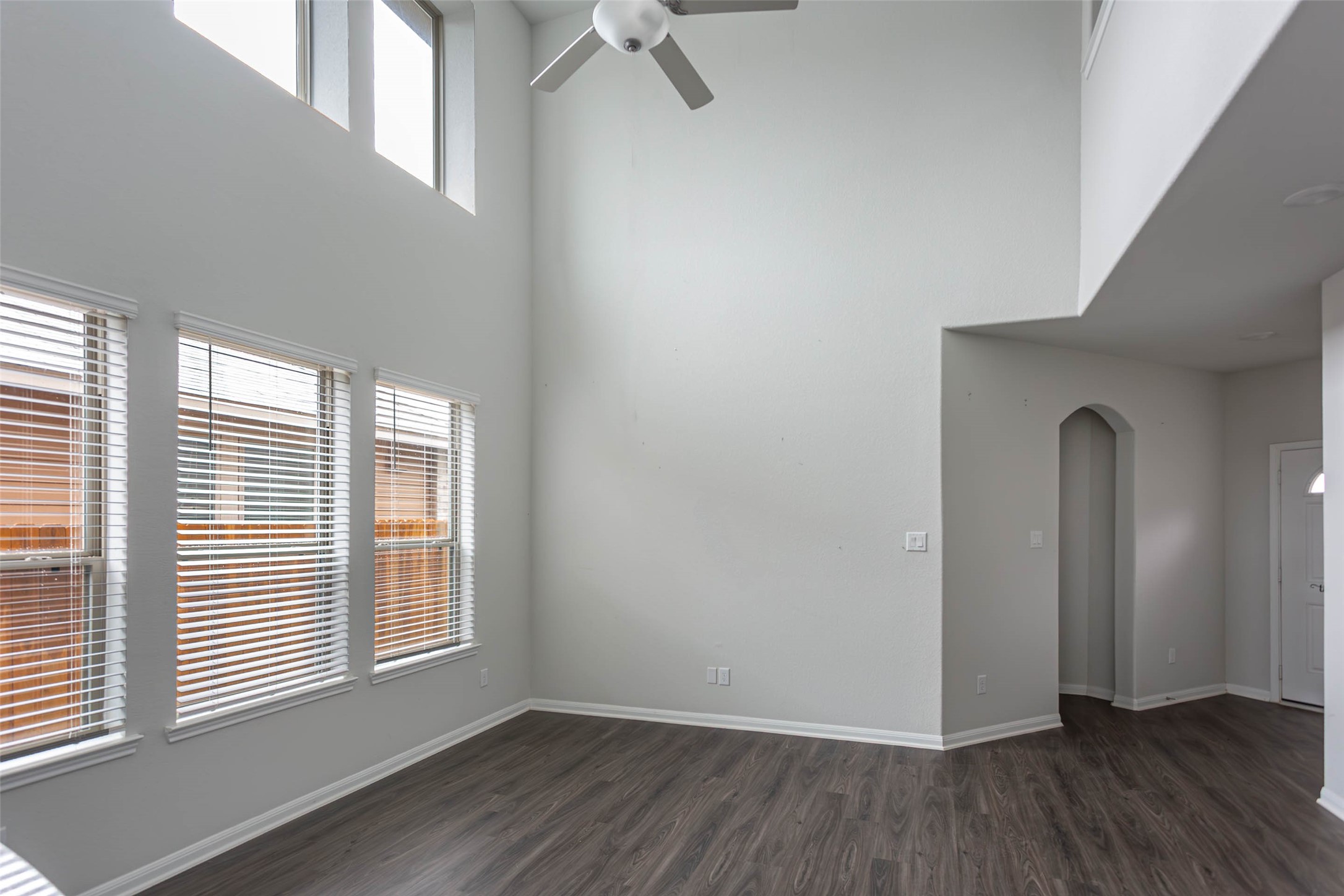 14212 Shasta Ridge Drive Conroe, TX 77303 - Photo 21 of 21 an empty room with wooden floor and windows