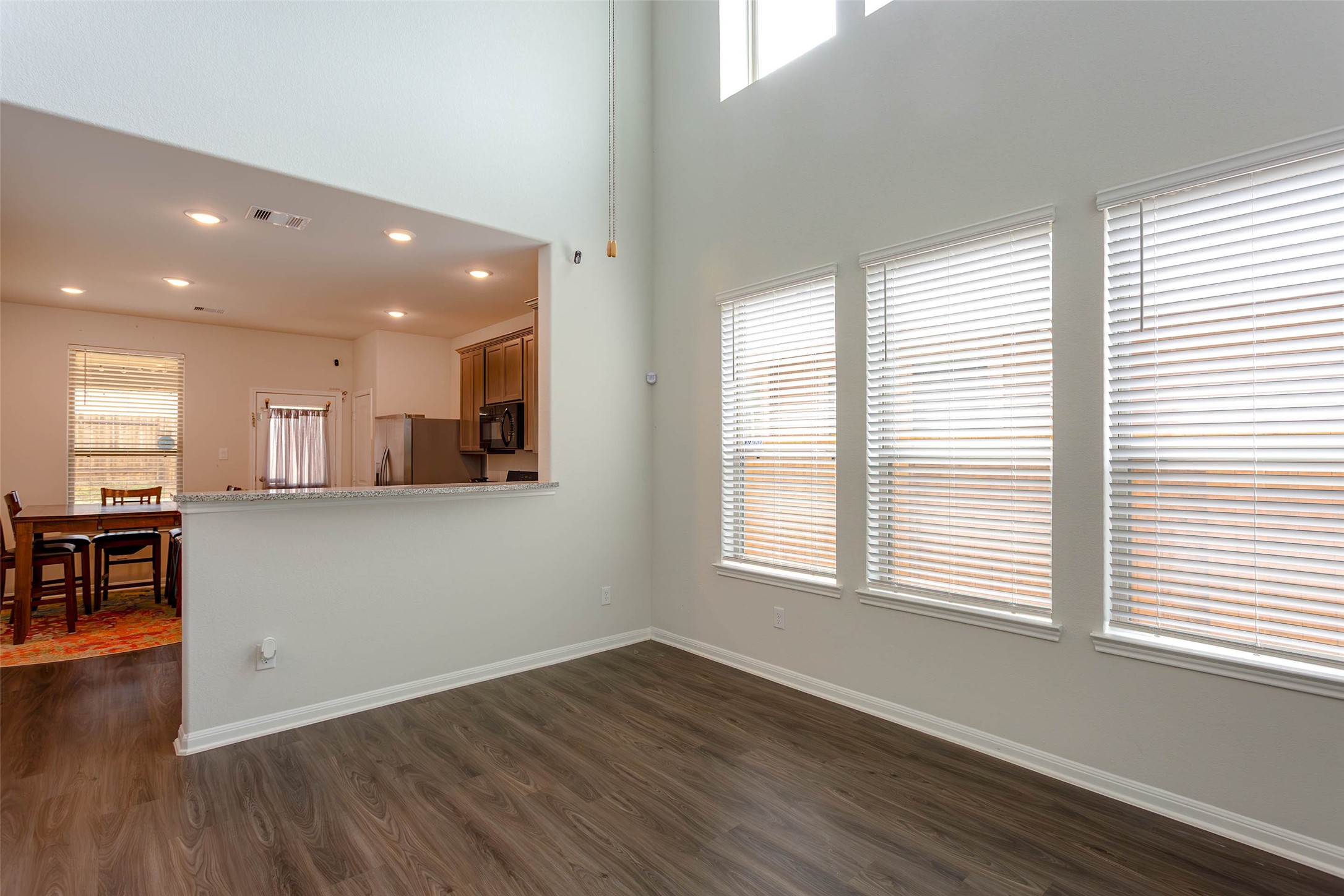 14212 Shasta Ridge Drive Conroe, TX 77303 - Photo 4 of 21 wooden floor in an empty room with a window