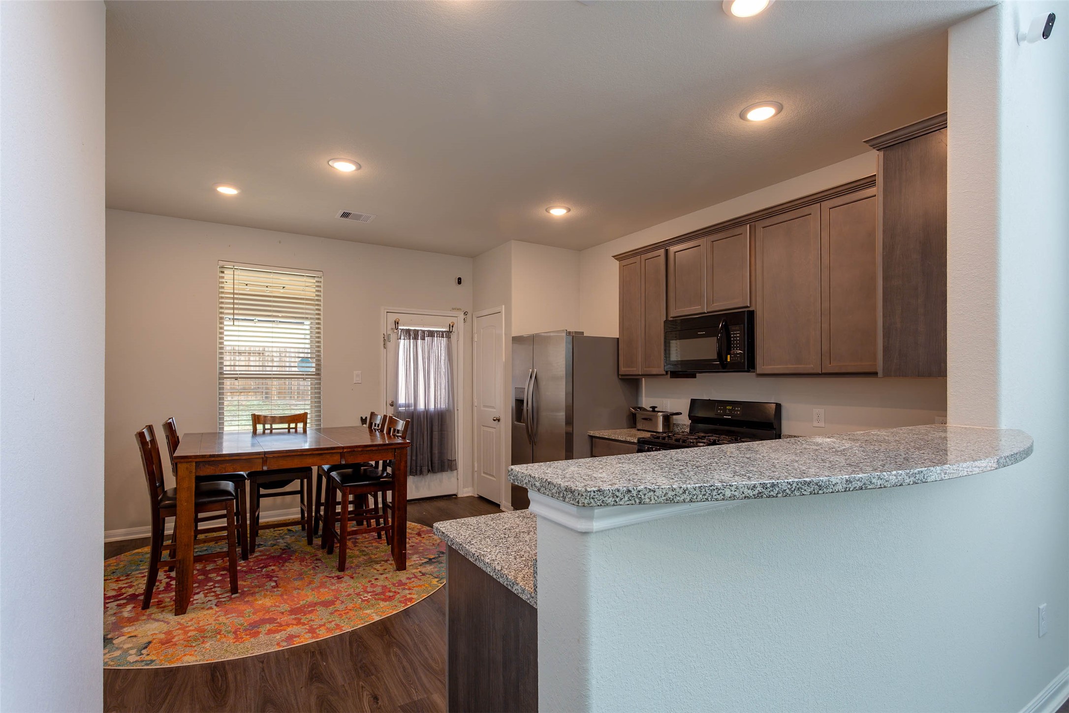 14212 Shasta Ridge Drive Conroe, TX 77303 - Photo 7 of 21 a kitchen with sink a microwave and cabinets