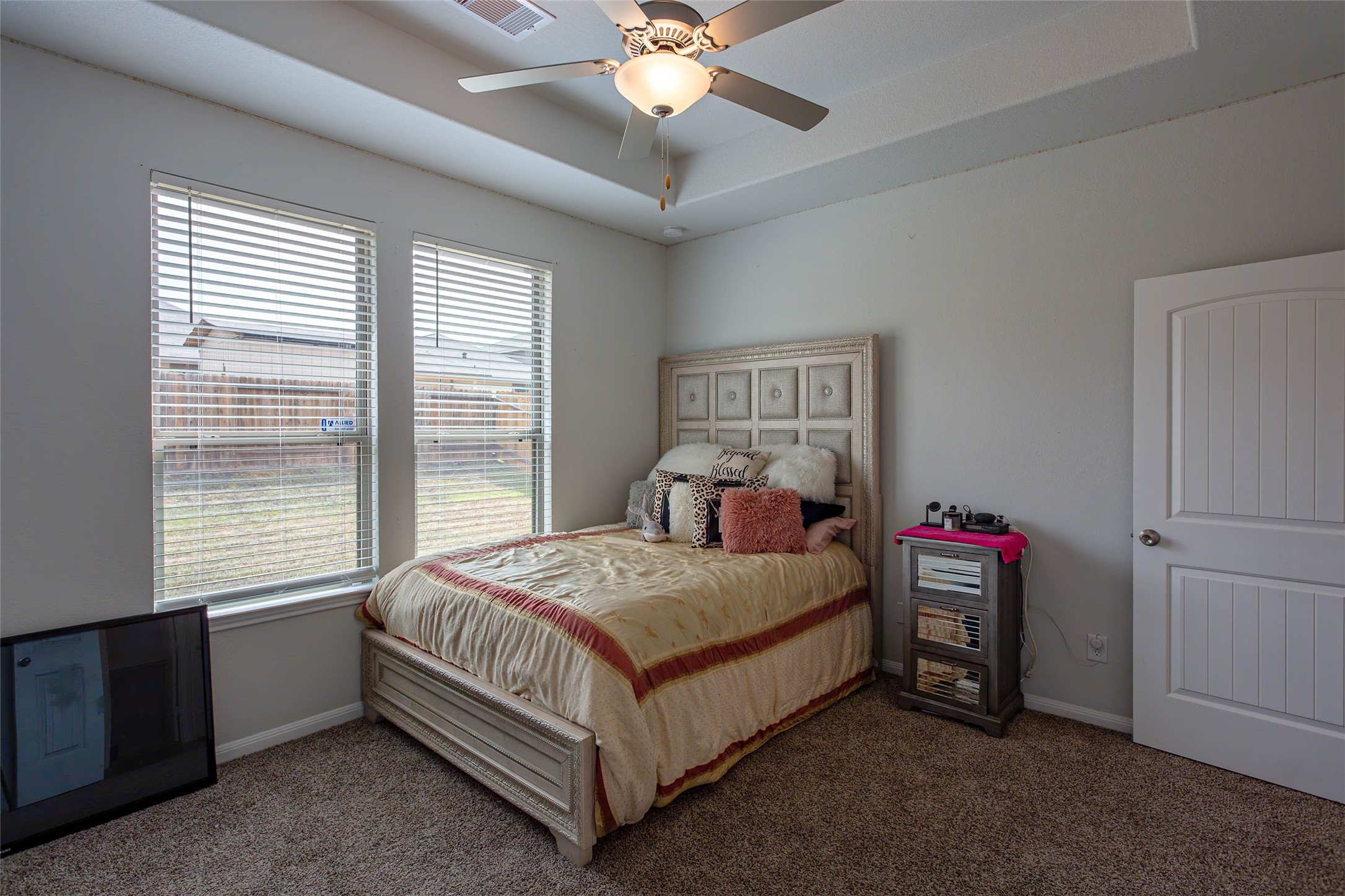 14212 Shasta Ridge Drive Conroe, TX 77303 - Photo 8 of 21 a bedroom with a bed and a chandelier