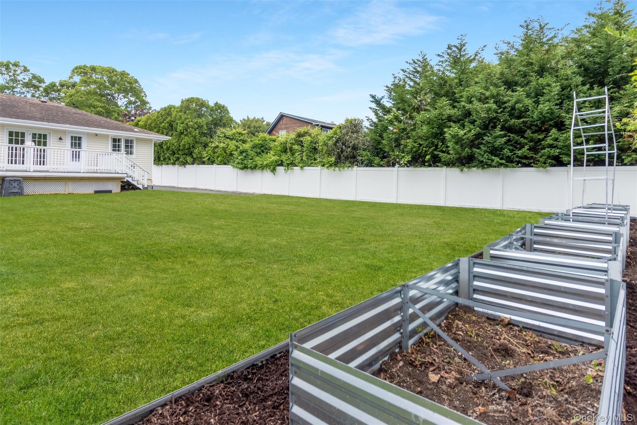 315 Wicks Road New Suffolk, NY 11956 - Photo 23 of 28 a view of a backyard with a garden