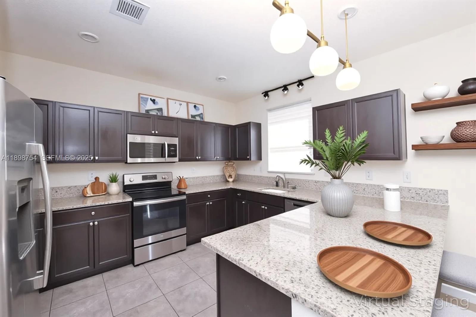 3412 West 103rd Terrace Hialeah, FL 33018 - Photo 11 of 44 a kitchen with granite countertop a sink a stove and wooden cabinets