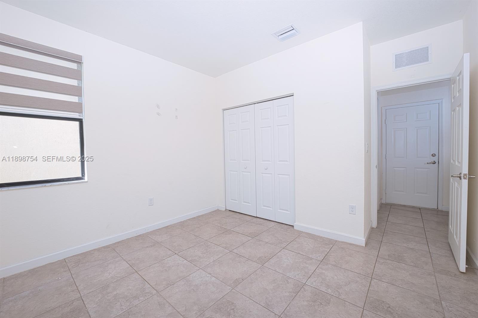 3412 West 103rd Terrace Hialeah, FL 33018 - Photo 15 of 44 a view of an empty room