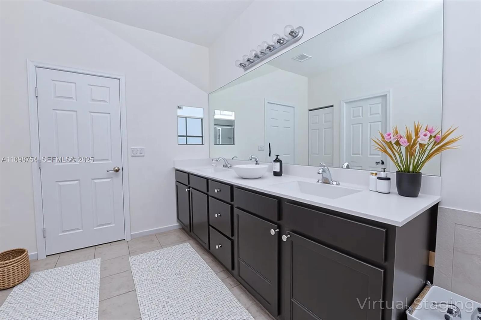 3412 West 103rd Terrace Hialeah, FL 33018 - Photo 25 of 44 a bathroom with a sink double vanity and a mirror