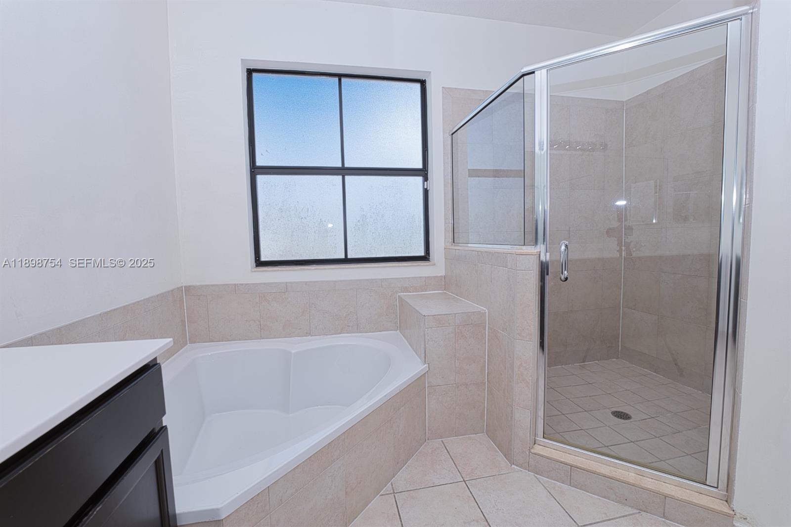 3412 West 103rd Terrace Hialeah, FL 33018 - Photo 28 of 44 a bathroom with a bathtub and a shower